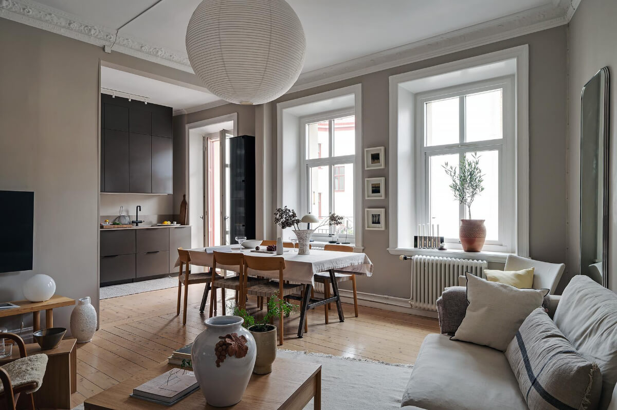 open plan living space wooden floor black kitchen