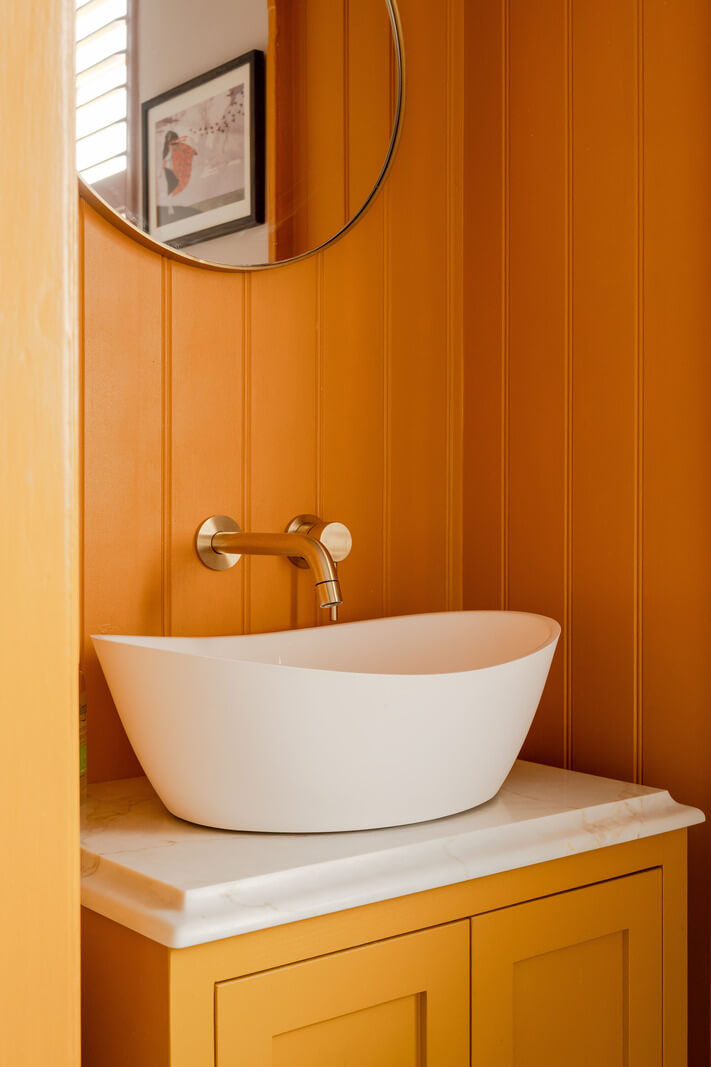 Vibrant Colors in a 19th-Century Regency Townhouse in England 20 orange bathroom sink cabinet paneled walls