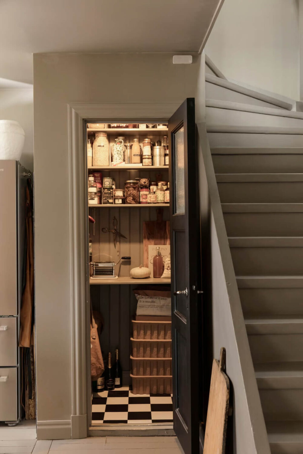 An Open-Plan Gray Home in a Former Textile Factory 9 pantry under stairs checkerboard floor nordroom