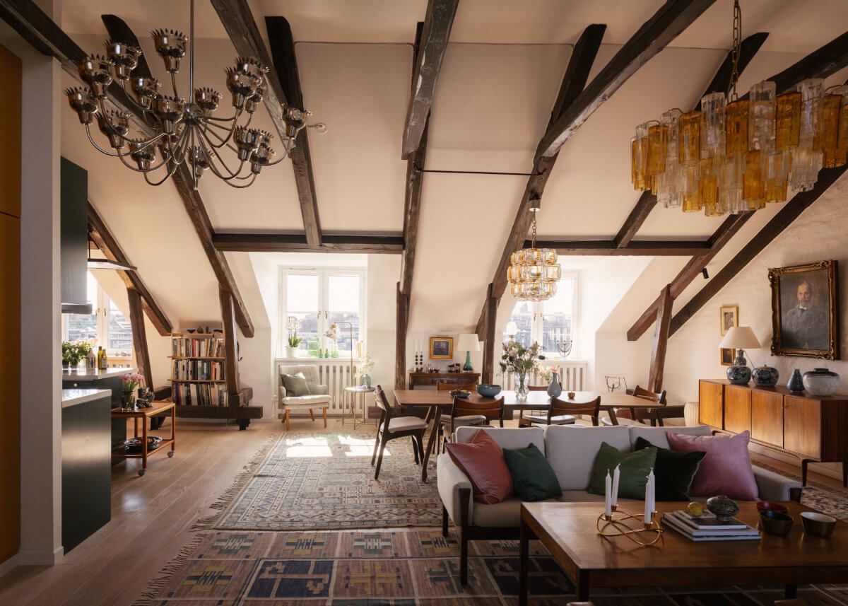 Revisiting a Spectacular Stockholm Penthouse with Exposed Beams 6 penthouse living space large rugs exposed beams