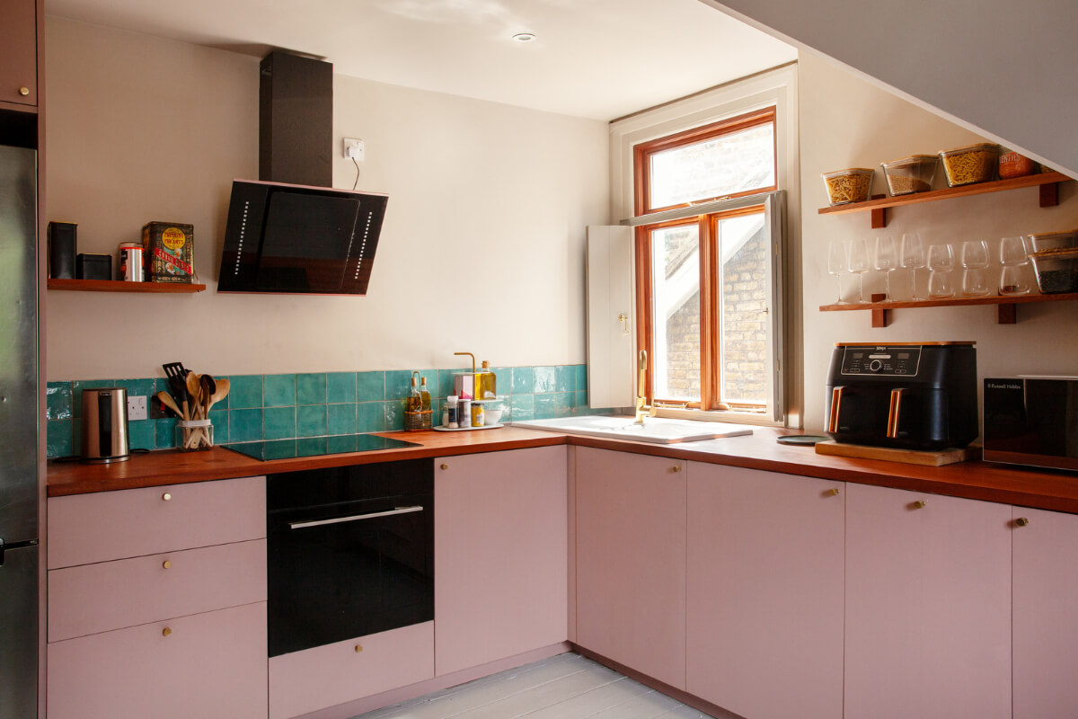 Pastel Tones and Midcentury Design in a Top Floor London Apartment 2 pink kitchen with turquoise tiles