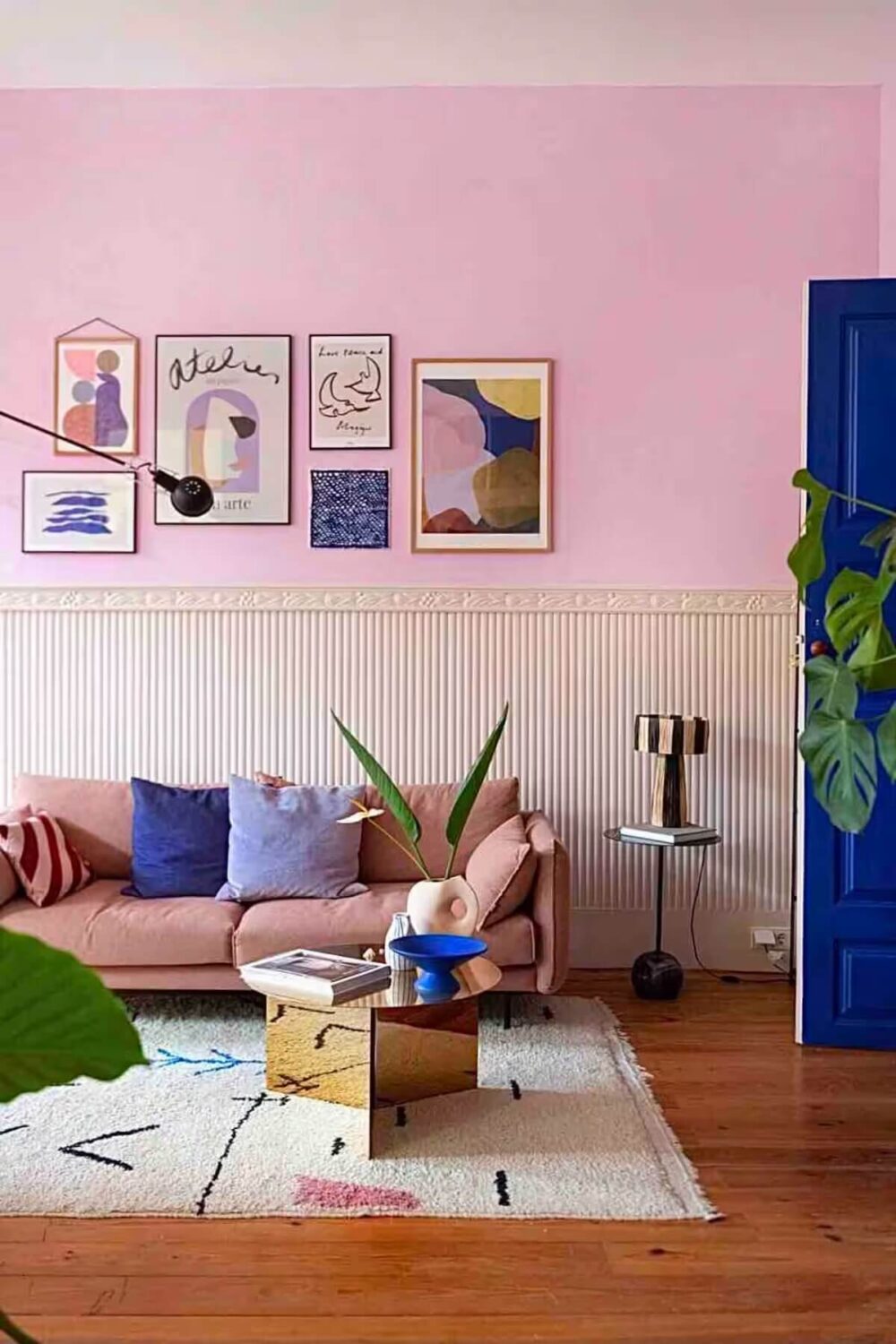 A Colorful Airbnb Apartment in Portugal 1 pink living room wooden floor blue door