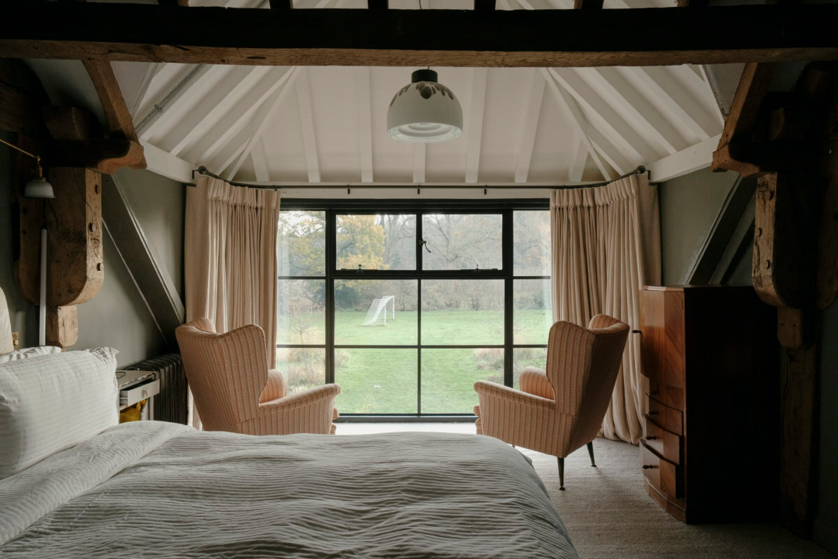 A Barn House with Vintage Decor and Exposed Beams 24 pitched ceiling exposed beams bedroom