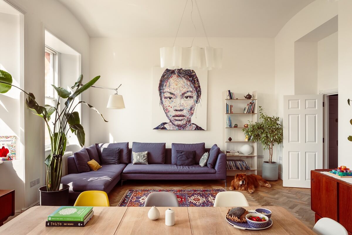 Benjamin Moore Color of the Year 2025: Cinnamon Slate 23 purple sofa in light living space with wooden floor