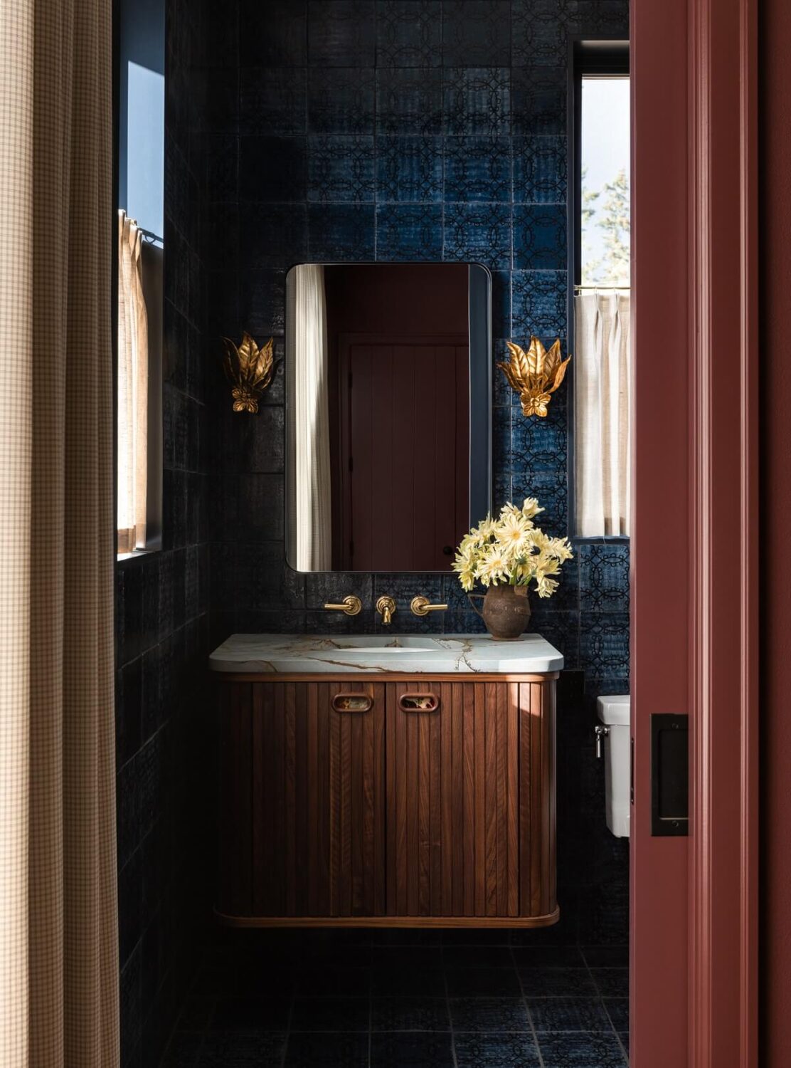 Moody, not Gloomy! Beautiful Dark Small Bathrooms 13 retro-bathroom-blue-tiles-gold-sconces-nordroom
