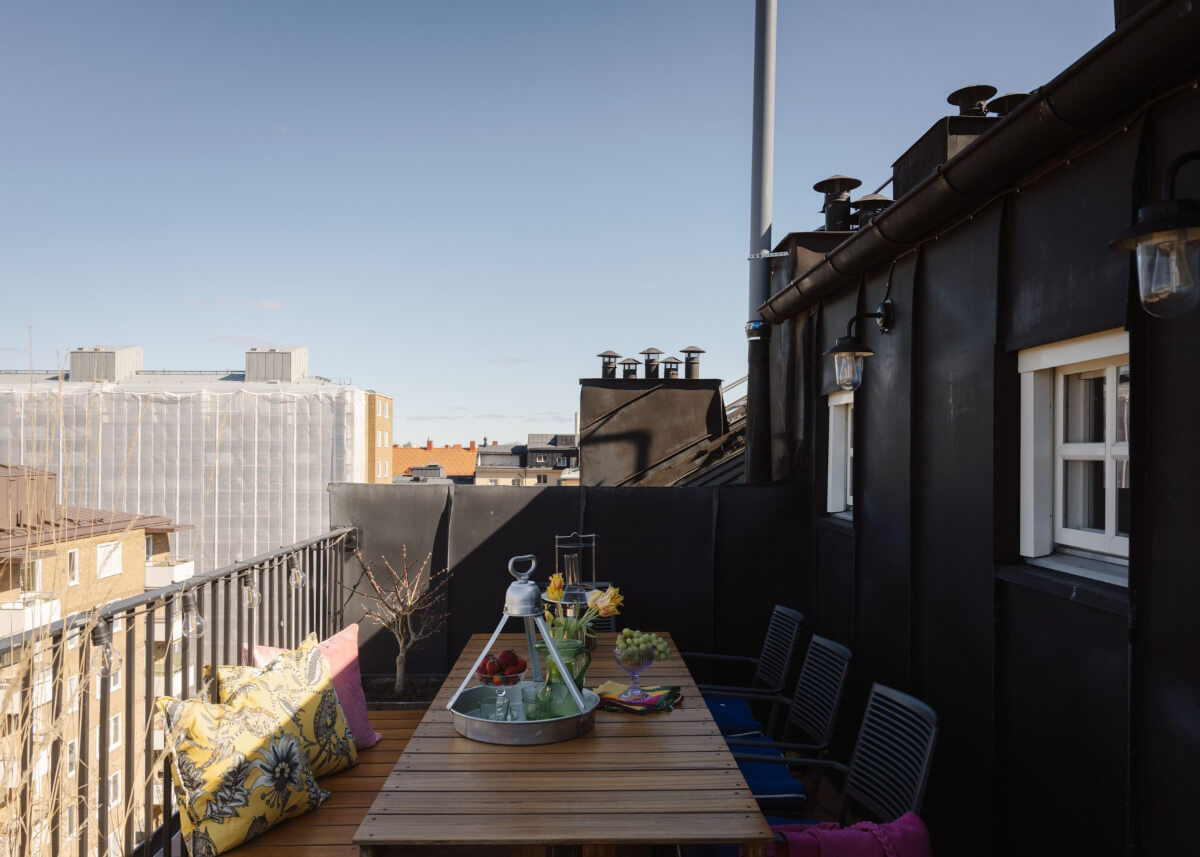 Revisiting a Spectacular Stockholm Penthouse with Exposed Beams 5 roof terrace dining spot