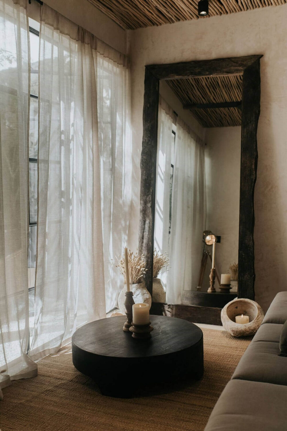 Rustic Wooden Elements in a Stylish Tulum Airbnb 8 round-coffee-table-jute-rug-large-rustic-wooden-mirror-living-room-nordroom