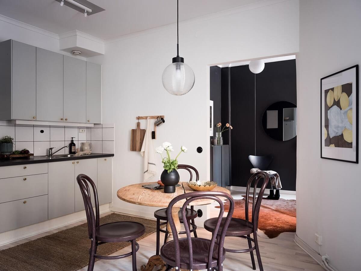 A Cozy Monochrome Gray Studio Apartment 18 round wooden dining table kitchen studio