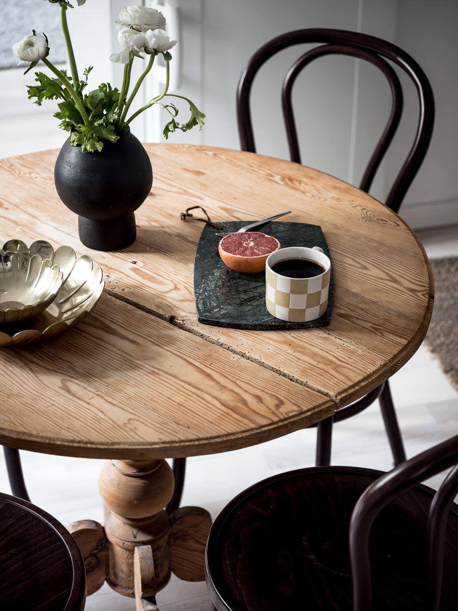 A Cozy Monochrome Gray Studio Apartment 10 round wooden dining table