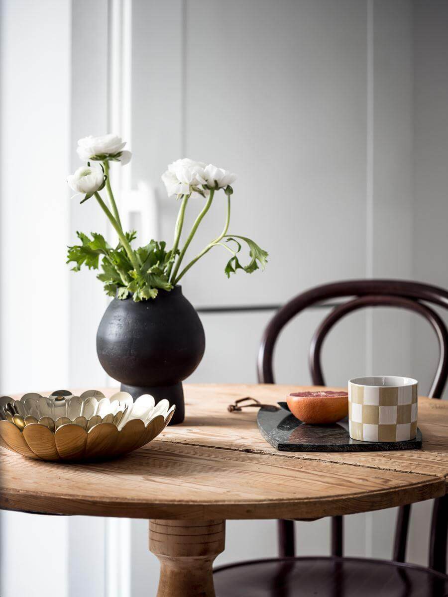 A Cozy Monochrome Gray Studio Apartment 14 round wooden table with bistro chairs