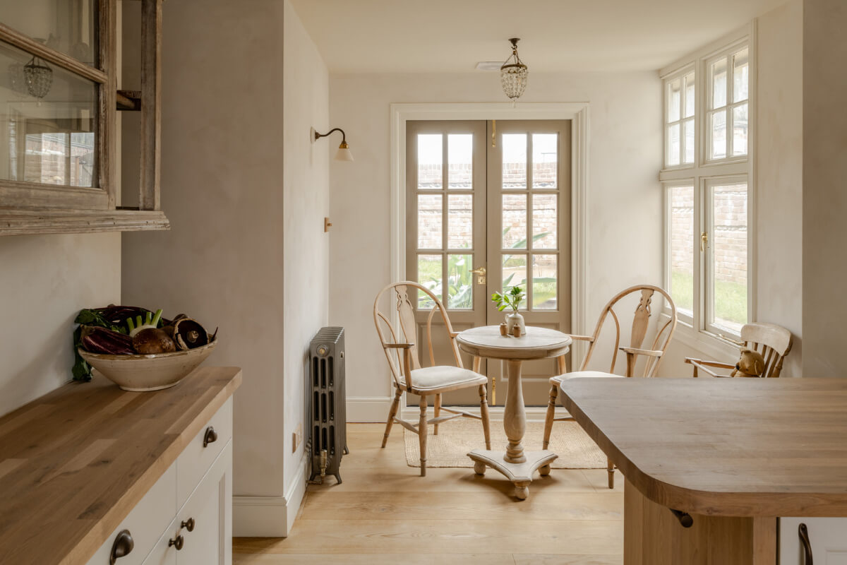 rustic farmhouse style kitchen with small round table in english cottage nordroom