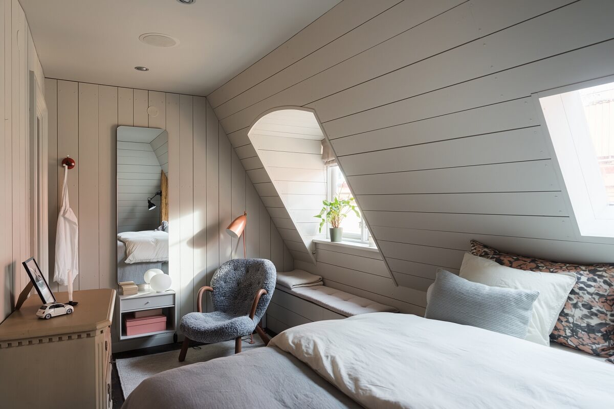 A Stylish Penthouse Apartment with Exposed Beams 24 scandi bedroom slanted ceiling