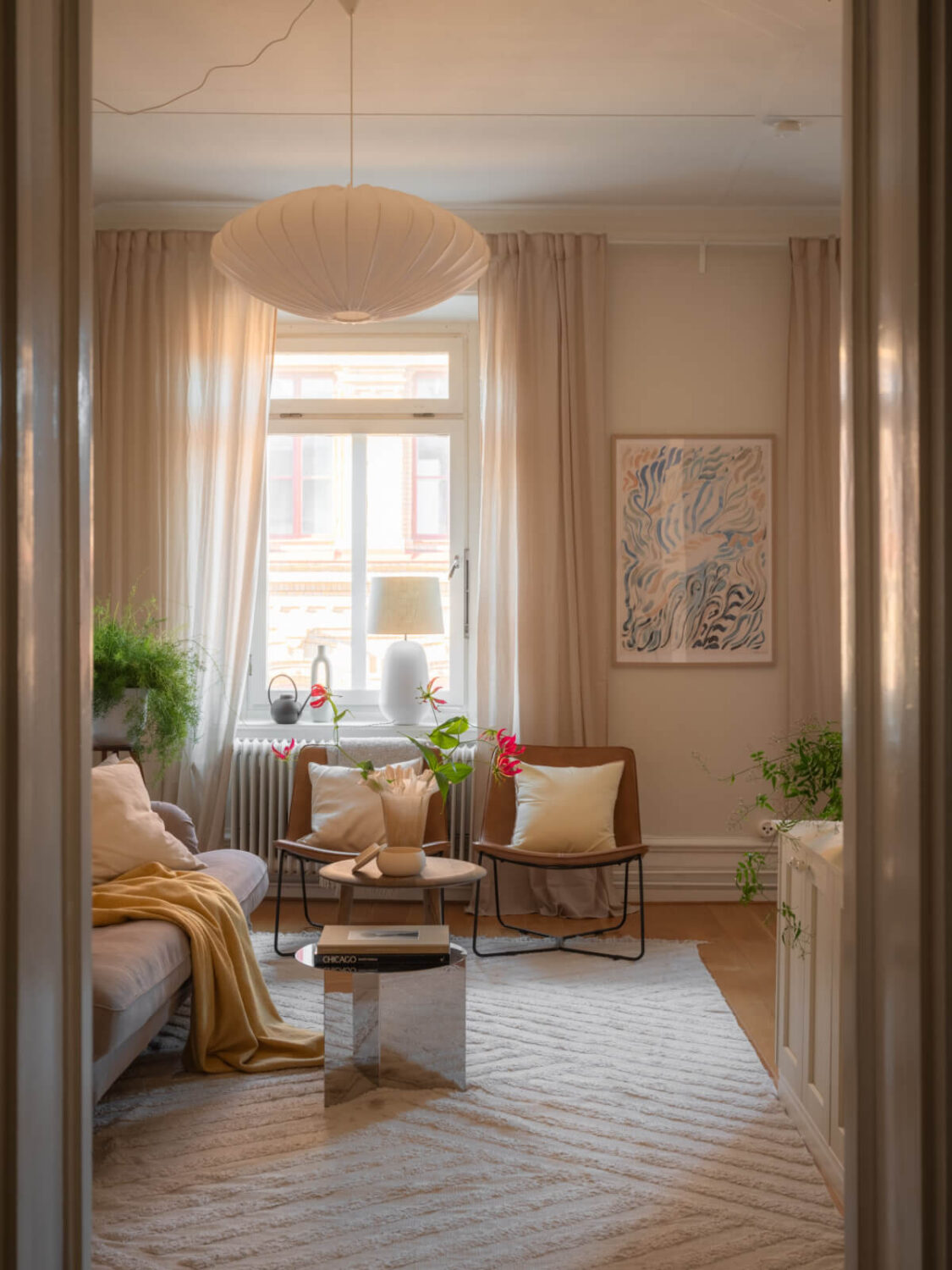 A 19th Century Apartment with a Dark Glass Room Divider 2 living room warm natural light