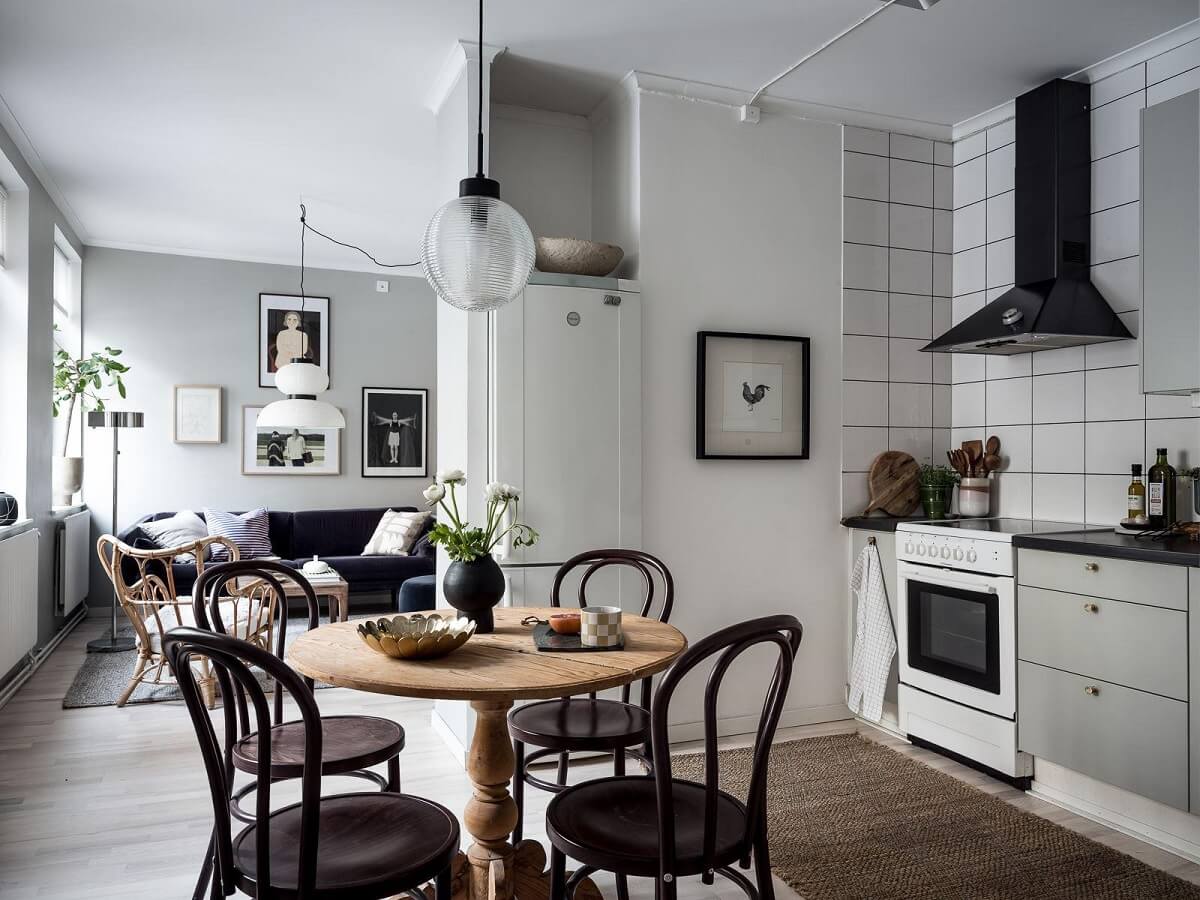 A Cozy Monochrome Gray Studio Apartment 13 scandi studio apartment light gray kitchen round wooden table nordroom