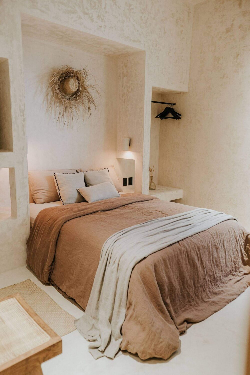 Rustic Wooden Elements in a Stylish Tulum Airbnb 23 serene-bedroom-earthy-colored-bedding-niche-for-bed-clothing-rack-nordroom