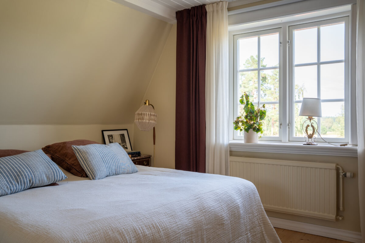 A Charming Historic Country House North of Stockholm 43 serene master bedroom slanted ceiling