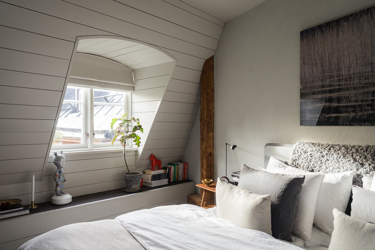 A Stylish Penthouse Apartment with Exposed Beams 21 slanted ceiling scandi bedroom