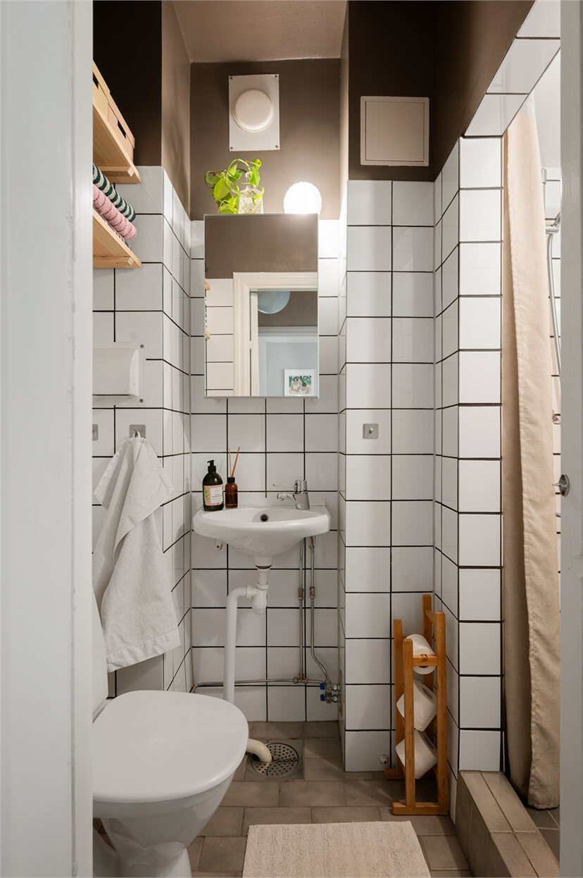 Midcentury Design and Colorful Decor in a Charming Studio Apartment 19 small bathroom white tiles