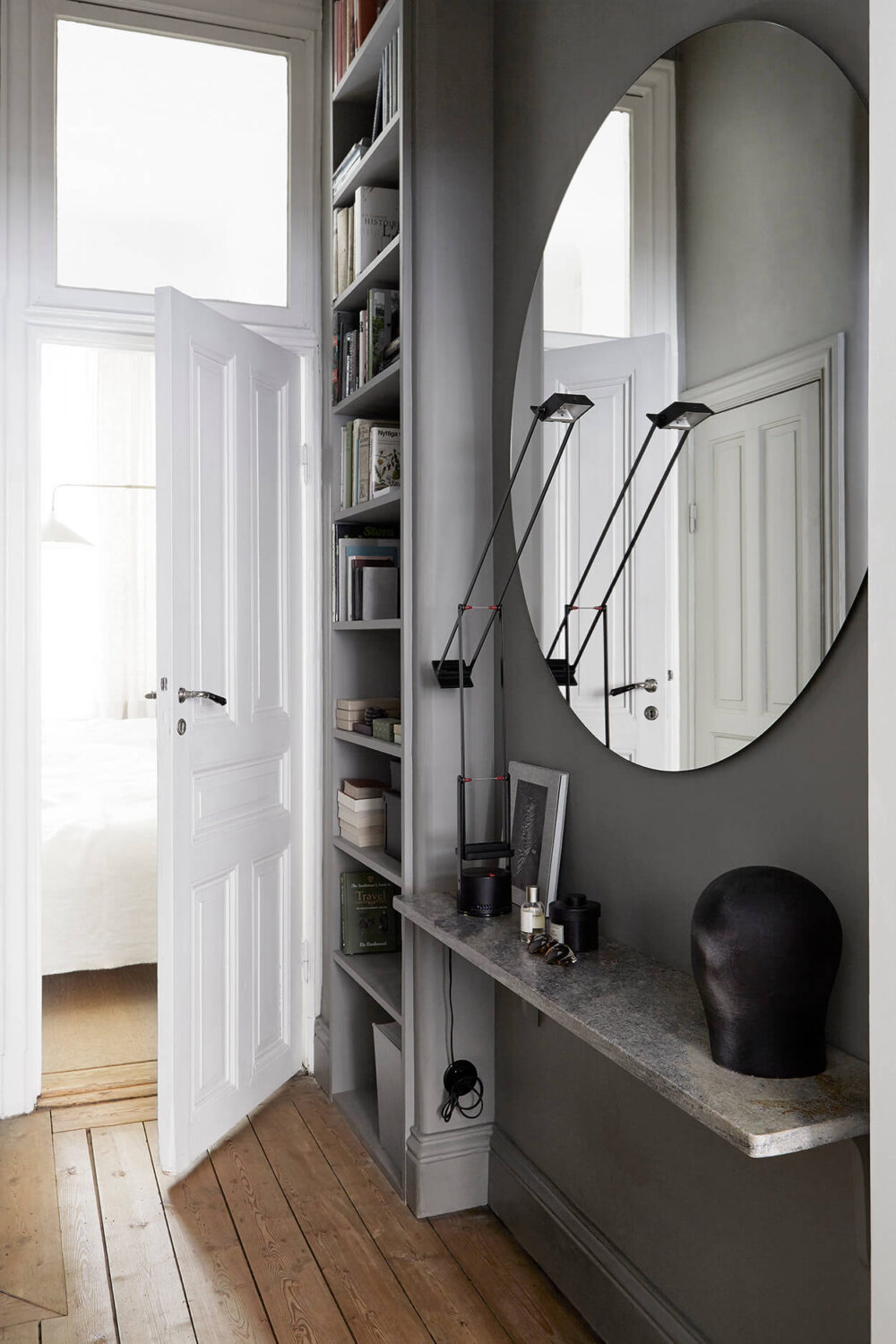 Stylish Small Entryway Ideas with Smart Storage Solutions 4 small entryway ideas with gray walls large round mirror floating shelf and floor to ceiling cabinets nordroom