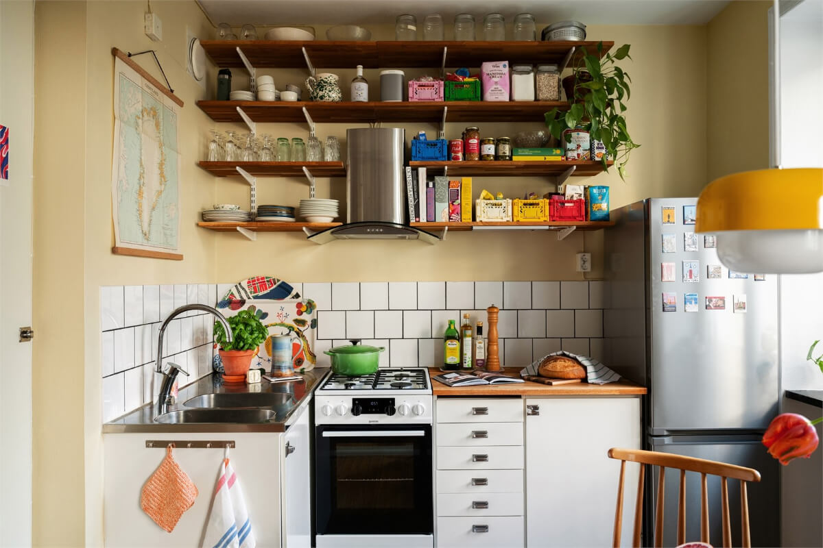 Midcentury Design and Colorful Decor in a Charming Studio Apartment 13 small kitchen butter-yellow walls wooden shelves nordroom