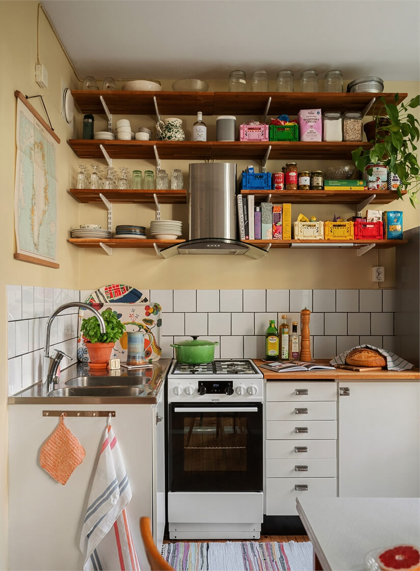 Midcentury Design and Colorful Decor in a Charming Studio Apartment 15 small midcentury kitchen wooden shelves butter-yellow walls nordroom