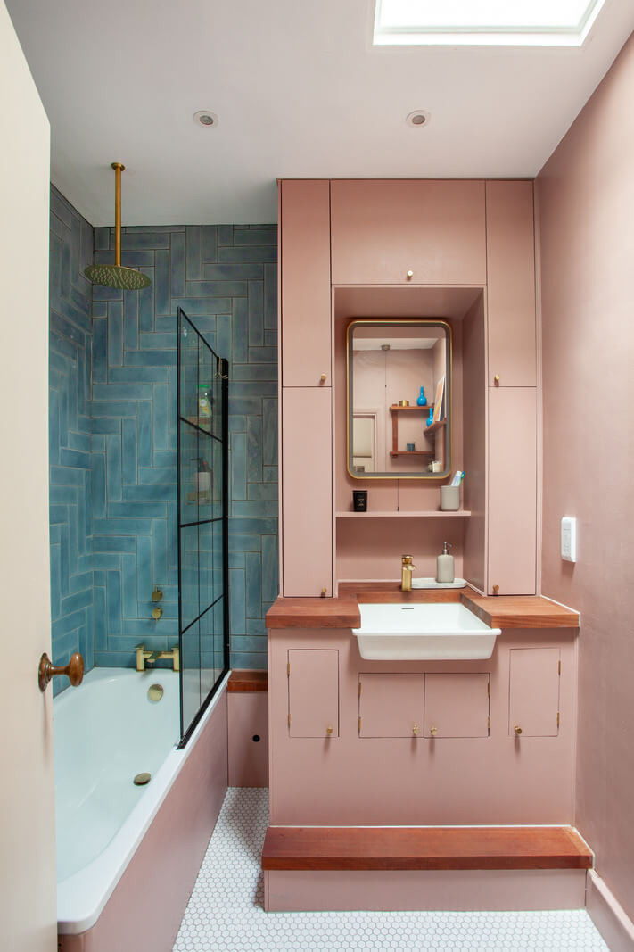 small pink and blue bathroom with bath