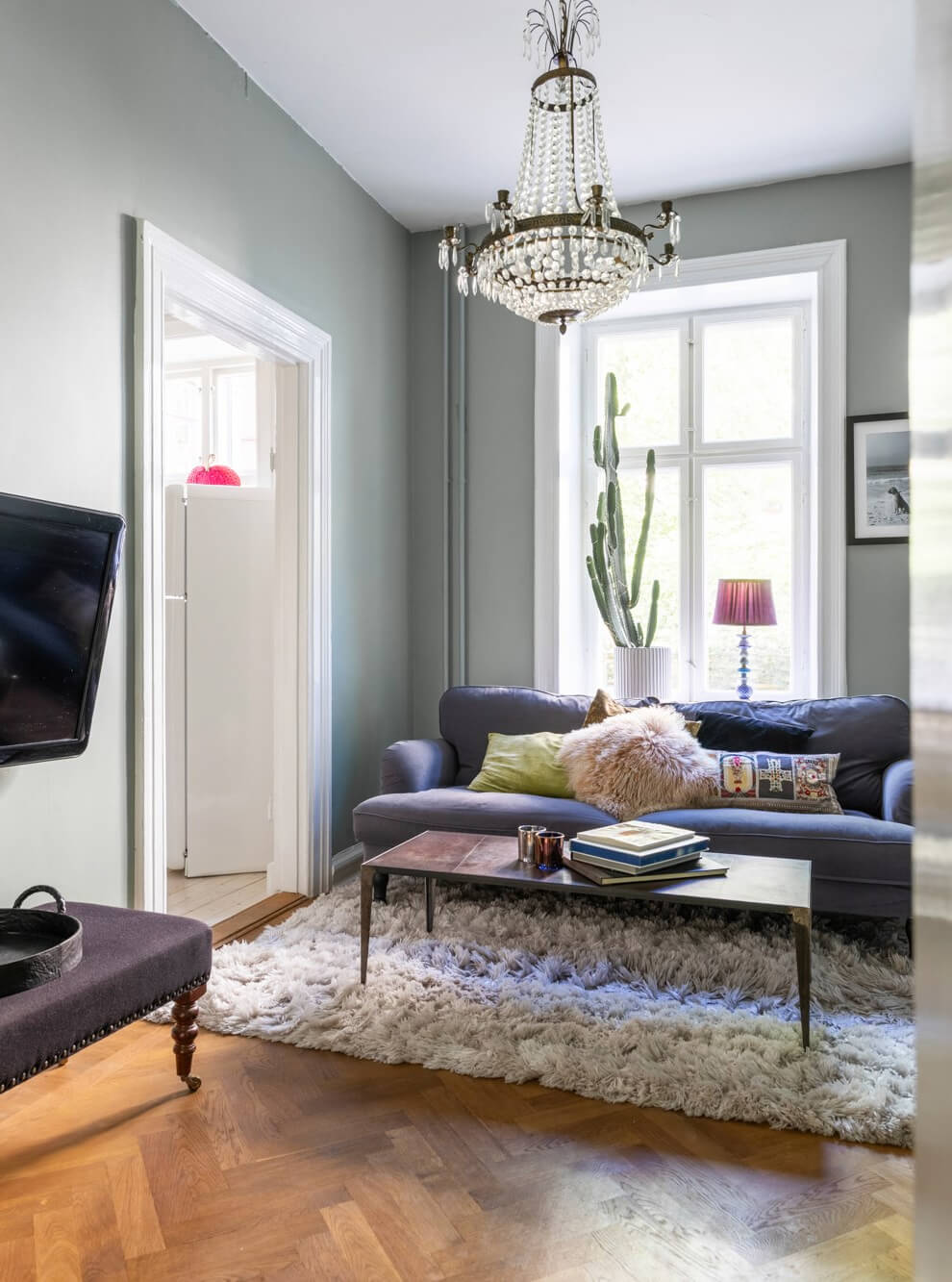 Classic Proportions and a Charming Kitchen in a Malmö Apartment 2 small sitting room blue sofa parquet floor