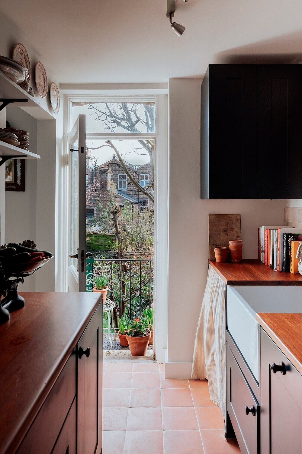 The Pros and Cons of a Wooden Kitchen Countertop 25 SmallBlueKitchenWithGardenViewsinaTinyLondonApartment TheNordroom8 The Pros and Cons of a Wooden Kitchen Countertop