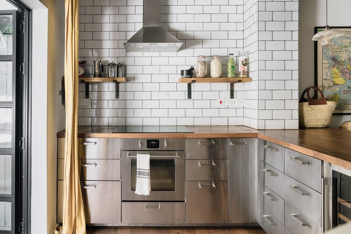 A Charming One-Bedroom Apartment with a Courtyard Terrace 3 stainless steel kitchen with white subway tiles