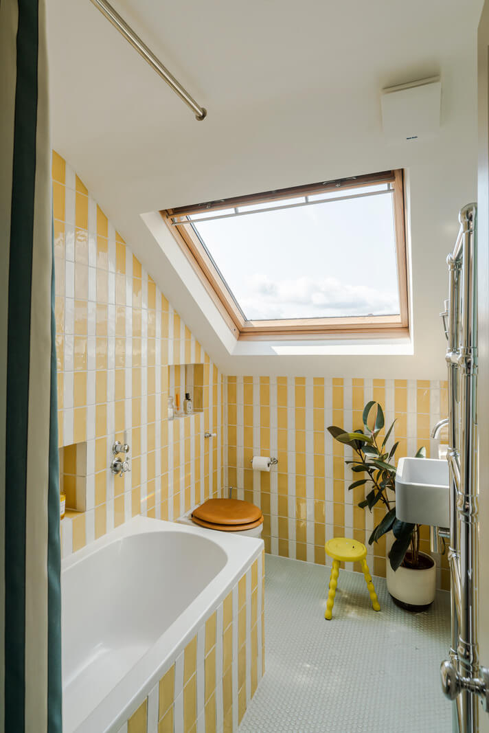 Color, Pattern, and Texture in a Renovated London Townhouse 22 striped yellow tilework small bathroom slanted ceiling