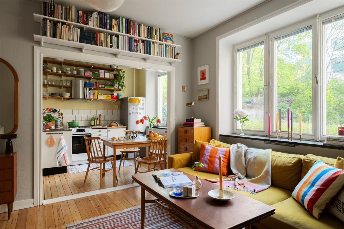 Midcentury Design and Colorful Decor in a Charming Studio Apartment 1 studio apartment bookshelves above the wide opening