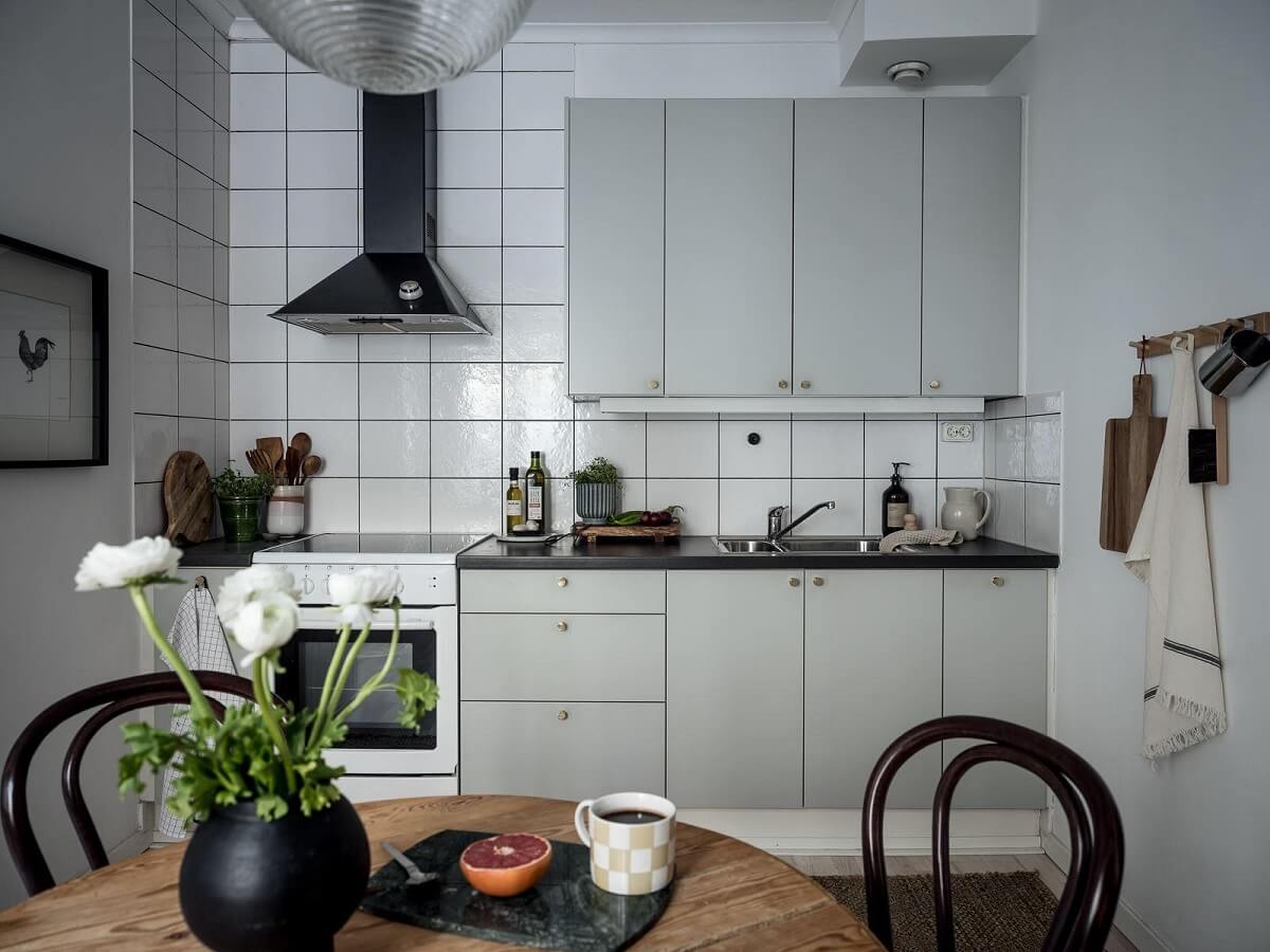 A Cozy Monochrome Gray Studio Apartment 16 studio apartment kitchen light gray cabinets
