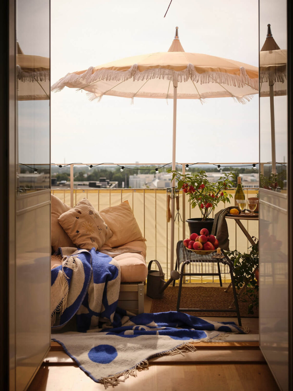 A 1940s Swedish Apartment with a Soft Yellow Kitchen 4 sunny balcony parasol
