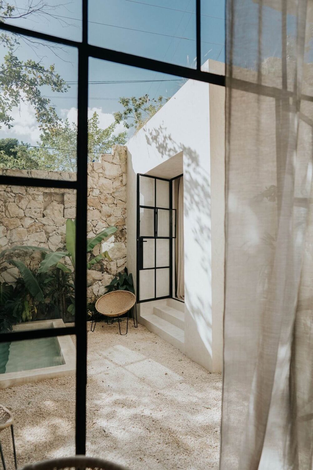 A Serene Design Apartment in Tulum 28 terrace-view-from-bedroom-steel-framed-glass-doors-nordroom