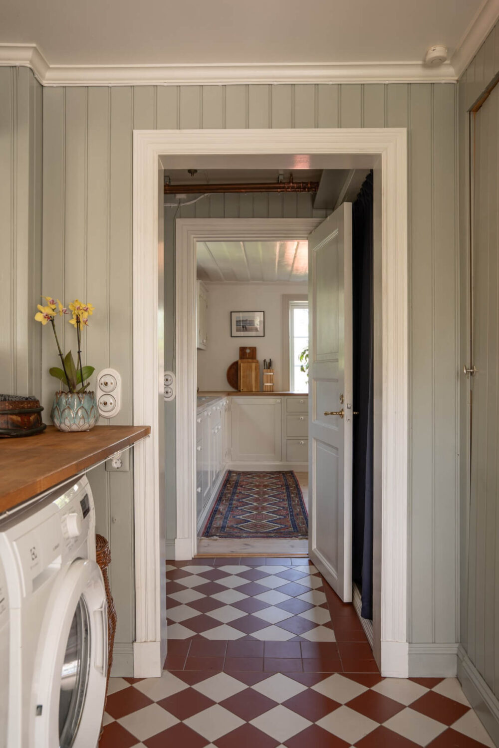A Charming Historic Country House North of Stockholm 22 utility room red and white checkerboard floor