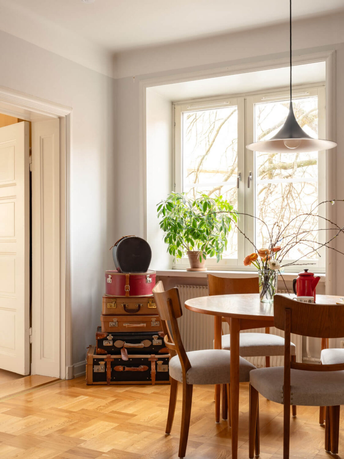 A Light Corner Apartment with a Pale Yellow Kitchen 15 vintage suitcases