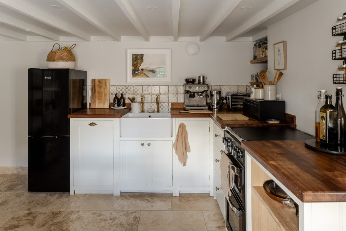 A Charming Stone Cottage with Period Features in Cornwall 5 white kitchen low ceiling butler sink