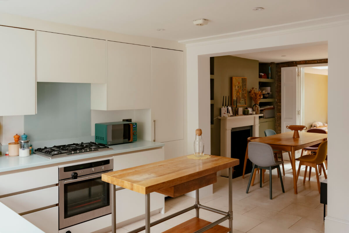 A Renovated Victorian Townhouse with a Small Split-Level Garden 11 white kitchen with dining space