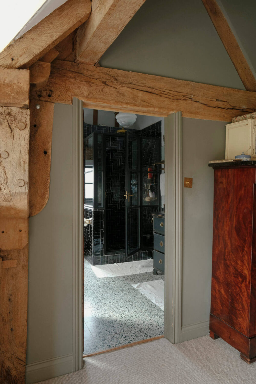 A Barn House with Vintage Decor and Exposed Beams 26 wooden beams and entry to bathroom