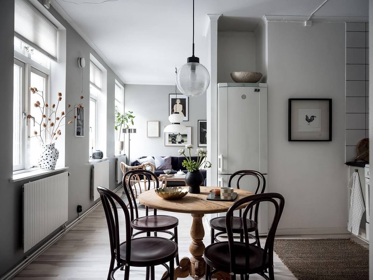 A Cozy Monochrome Gray Studio Apartment 9 wooden dining table scandinavian studio