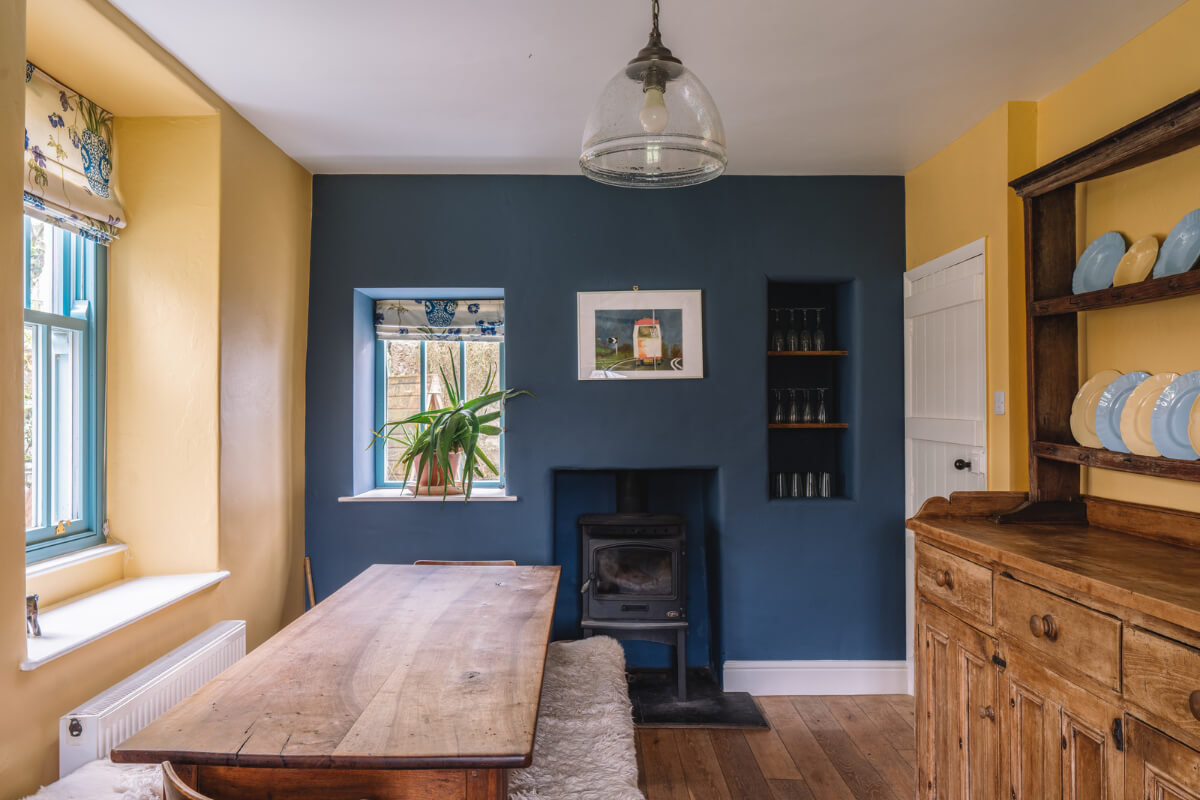 A Colorful 19th-Century Cottage in the Lake District 6 yellow and blue walls kitchen rustic table
