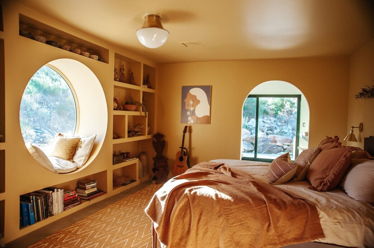 A Colorful Airbnb Home in the Morongo Valley 16 yellow-bedroom-painted-ceiling-built-in-bookcases-round-mirror-nordroom