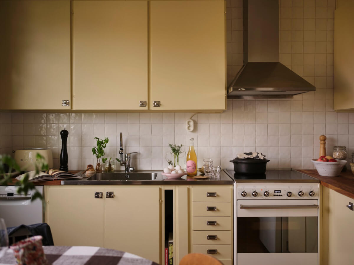 A 1940s Swedish Apartment with a Soft Yellow Kitchen 11 yellow kitchen cabinets