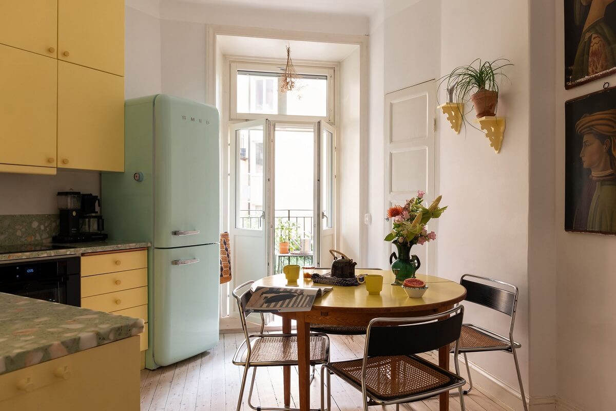 Yellow Kitchen Design Ideas (with Paint Colors) 8 yellow kitchen with mint green smeg fridge and round table nordroom