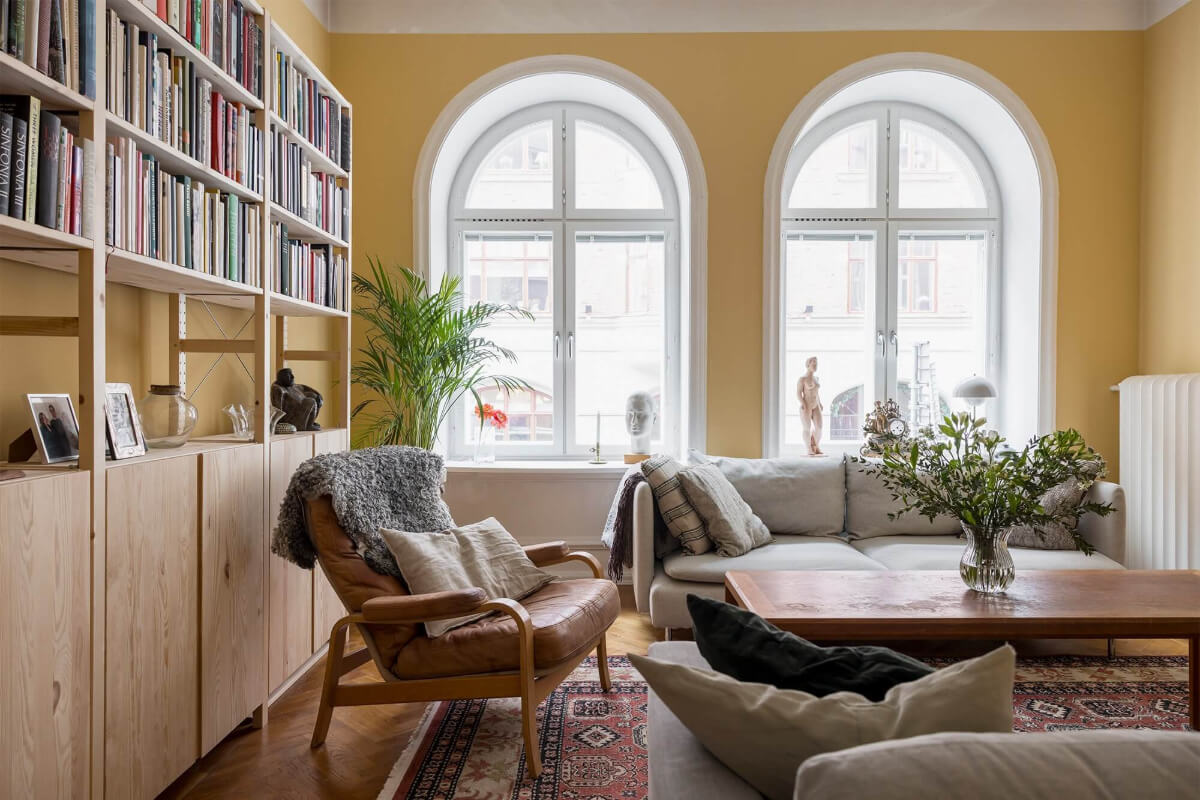 The Color Trends for 2025: Warm, Natural Shades and a Cheerful Accent 68 yellow living room with arched windows and ikea ivar bookcases nordroom