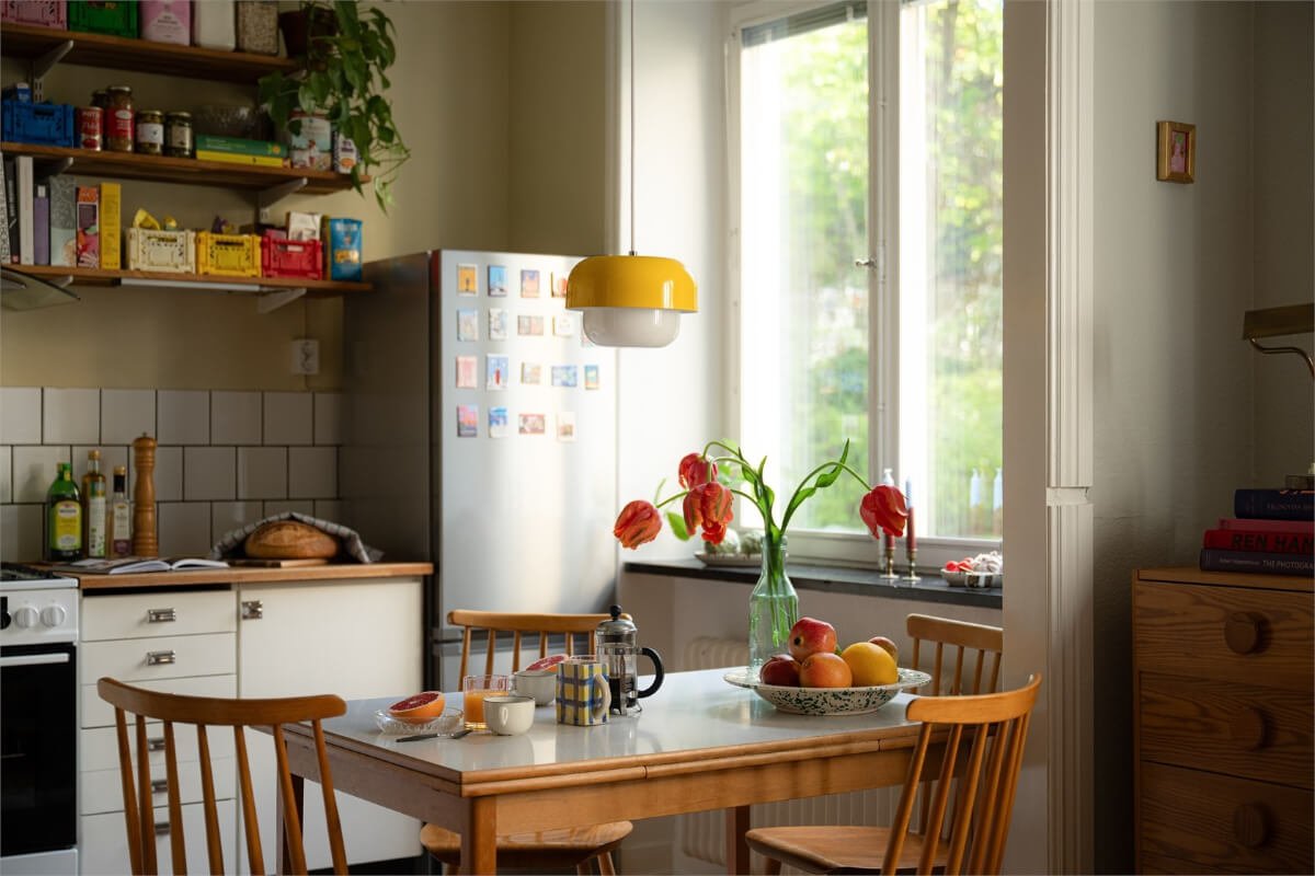 Midcentury Design and Colorful Decor in a Charming Studio Apartment 12 yellow pendant formica table