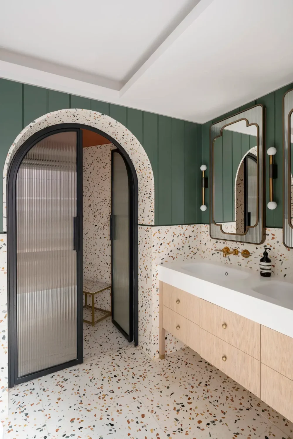 40+ Colorful Bathrooms That Will Spruce Up Your Home 8 bathroom-green-walls-terrazzo-tiles-double-sink-arched-ribbed-glass-doors-nordroom