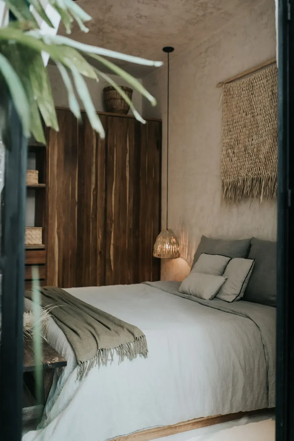 Rustic Wooden Elements in a Stylish Tulum Airbnb 16 bedroom-gray-blue-bedding-rustic-wooden-wardrobe-nordroom