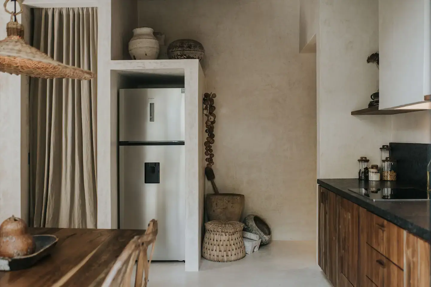 Rustic Wooden Elements in a Stylish Tulum Airbnb 15 kitchen-rustic-wooden-cabinets-niche-fridge-nordroom