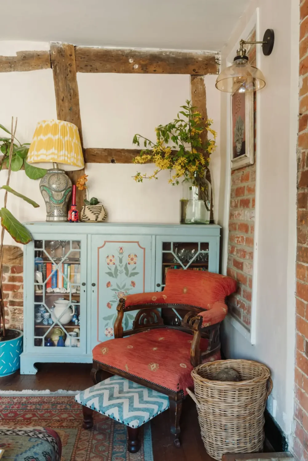 A Historic English Cottage Decorated in Pink & Blue Tones 2 living room detail painted light blue cabinet